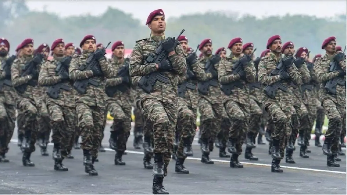 An officer cadet on parade in ceremonial dress with the national tricolour sash